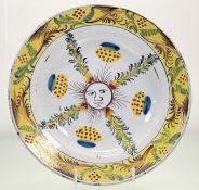 An English Delftware charger, mid-18th century, possibly Bristol, polychrome painted to the centre