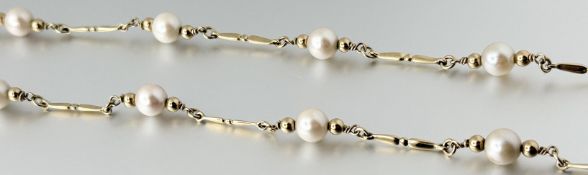A 9ct gold chain necklace, the fancy links spaced by uniform cultured pearls, length 59cm, 14.5