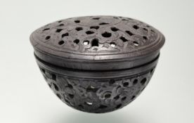 A Chinese carved coconut shell cricket cage, pierced with an intricate foliate design. 5cm by 7.