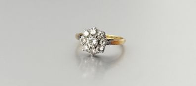 A diamond cluster ring, first half 20th century, the central round brilliant-cut stone (weighing