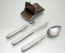 A campaign set of white metal folding knife, fork and spoon, each marked “Foreign”, in a leather