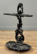 A cast-iron stick stand, of three divisions, cast with flowers and foliage the base of the back cast