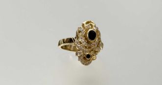 An 18ct gold ring collet-set with an oval-cut sapphire and further small round-cut sapphires in a