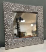 A contemporary square wall mirror with moulded all-over 'bubble' effect and silvered textured finish