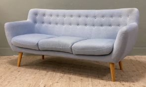 A modern three-seater sofa, with button back and three cushions to front, raised on tapered turned