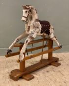 A 20th Century hardwood rocking horse, real horsehair mane with leather saddle, raised on oak