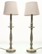 A pair turned wooden green painted table lamps, each with a grey lamp shade. (h excluding shade