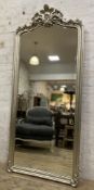 An impressive Rococo-style mirror, floor-standing with bevelled plate, enclosed within a moulded