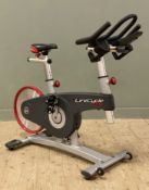 A LifeCycle GX exercise bike. H. 121cm L. 125cm D. 58cm