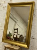 A modern hardwood-framed wall mirror, rectangular plate enclosed within gold-finish moulded frame: