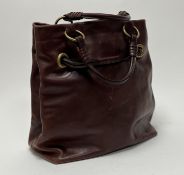 A vintage Celine brown leather handbag with brass accents, complete with two interior pockets and