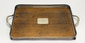 An Edwardian oak panel top epns mounted twin handled drinks tray with inlaid plaque and crest and
