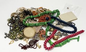 A large collection of costume jewellery to include stained wooden bead necklaces, gilt metal chains,