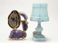 A carved alabaster table lamp, raised on square stepped base, with carved mounted shade, in a blue