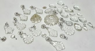 A collection of clear crystal faceted chandelier prisms and lustre drops with scalloped edges,