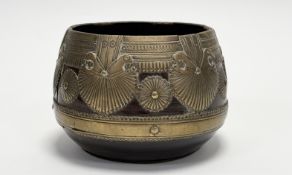 An Eastern hardwood bowl with strap work brass mounted panel, lotus leaf and flower head design on a