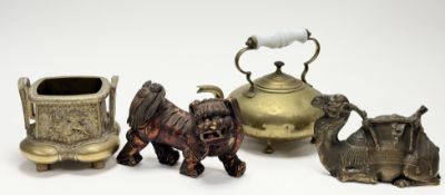 A collection of various decorative comrpsing, a brass plaque of a seated camel, a brass teapot, with