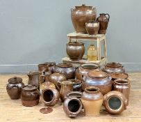 A large collection of stoneware teracotta glazed jars / jugs and flagons etc, some with incised