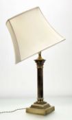A late 19thc brass corinthian column table lamp, raised on a square stepped plinth base together