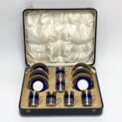 A George V cased set of six Crescent china lapis blue and gilt coffee cans with Birmingham silver