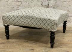 A modern Ottoman footstool, of square form with curved sides covered in pale blue geometric