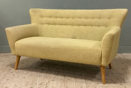 A modern two-seater sofa, with button back upholstered in yellow-green fabric, raised on turned