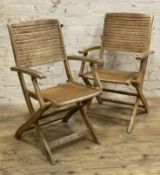 A pair of folding teak garden armchairs: H. 92cm W. 56cm D. 58cm