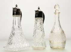An early 20thc cut glass claret jug, with silver plated hinged top and bearded man spout (h-29cm), a