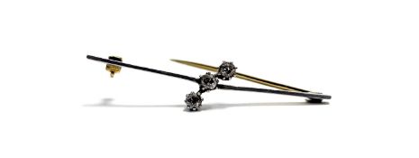 An Edwardian yellow metal and white metal mounted bar brooch set three old mine cut diamonds, each