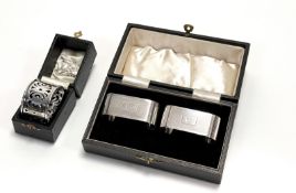 A pair of George V Birmingham silver rectangular engine turned napkin rings with engraved names Anne