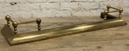 A Victorian brass fire fender, extendable front with ball finials to corners: H. 19cm L. 132cm