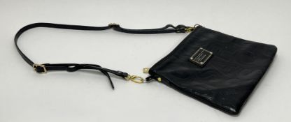 A vintage Marc by Marc Jacobs black leather cross body bag with one internal zip pocket and one