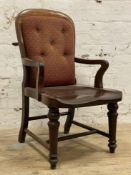 A Victorian mahogany library chair, upholstered button-back with open arms and saddle seat, raised