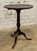 A Georgian mahogany wine table, circular top on central baluster support and splayed tripod base: H.