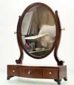 An Edwardian mahogany dressing table mirror, in oval form mounted within a stringing inlay frame