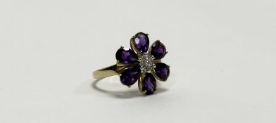 A QVC 9ct gold floral dress ring set seven central diamond points within a surround of six pear