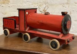 An early 20th century wood and tin toy train, red-painted locomotive on six wheels: H. 30cm L. 75cm