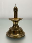 A brass capstan-style candlestick with wick cover to top on a domed spreading foot (h. 21cm)