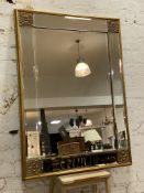 A modern rectangular wall mirror, central bevelled plate enclosed within four smaller bevelled