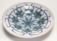 A Contemporary School Studio Pottery centrepiece bowl, decorated in a nabstract floral motfi