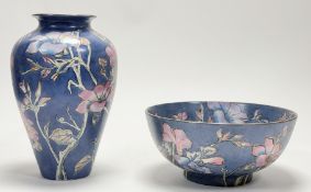 A Universal Merchants porcelain fruit bowl (h-12cm) and balsuter vase (h-28cm) , both in a flowering