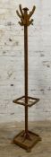 A mid-century pitch pine coat stand, eight hooks to top on square support and stick stand to base: