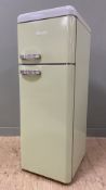 A modern retro-style fridge-freeze by Swan, finished in sage green with freezer over fridge. H.