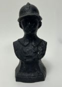 A cast iron bust of a World War One French Soldier on a shaped base (h. 22cm)