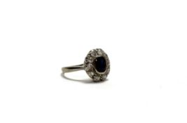 A white metal sapphire and diamond cluster ring the oval facet cut sapphire approximately 0.45ct