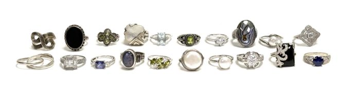 A collection of twenty various silver rings some set with paste, shell, peridots etc sizes R/S 129.