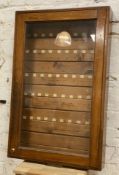 An Edwardian mahogany glazed cabinet, with sixty numbered slots to interior enclosed within a