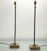 A pair of tall Pooky 'Babel' brass table lamps, raised on stepped bases with green rope leads (h.