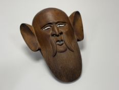 A carved Japanese Nok wooden theatrical mask, with big ears and beard. (l-39cm w-20.5cm)