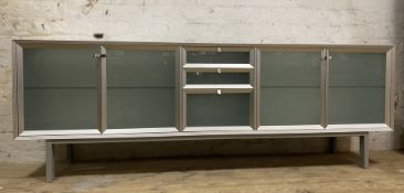 An Italian glass and aluminium sideboard, designed by Antonia Astori for Driade, fitted with three